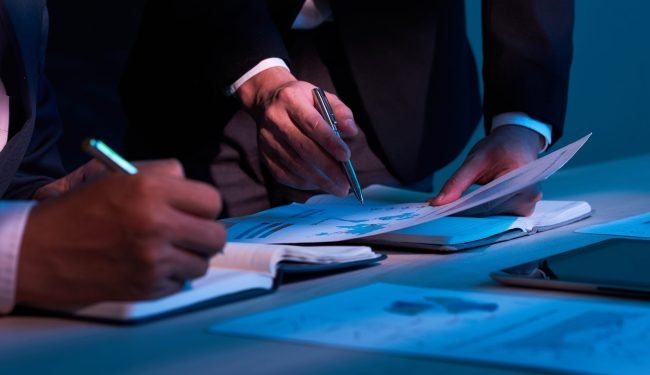 Close-up image of business partners working with financial documents
