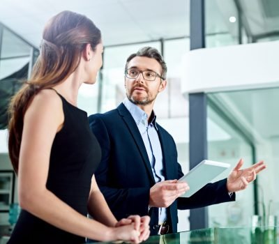 Cropped shot of two businesspeople talking in the office.